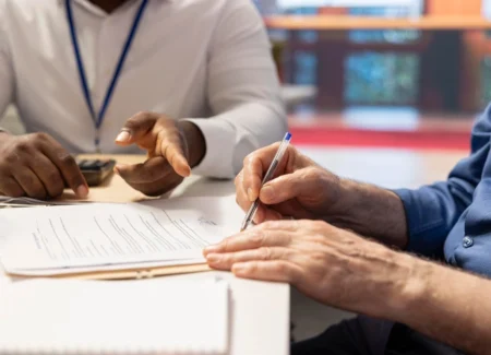 Client signing an important legal agreement with guidance from a family law attorney